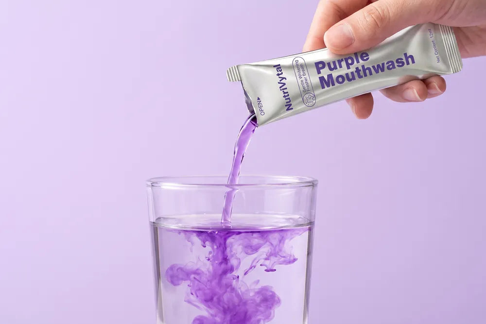 Purple mouthwash poured into a glass